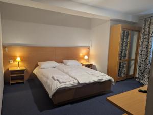 sypialnia z dużym łóżkiem z 2 stolikami nocnymi i 2 lampami w obiekcie Ośrodek Wypoczynkowy Watra w Korbielowie