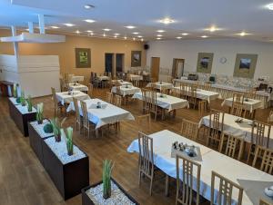 an empty dining room with tables and chairs at Ośrodek Wypoczynkowy Watra in Korbielów