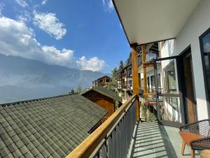 a balcony of a house with a view of the mountains at Sapa Catcat Hills Resort & Spa in Sa Pa