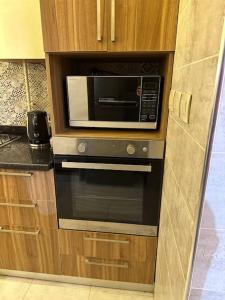a microwave oven sitting inside of a kitchen at Luxurious apartment in cairo in Cairo
