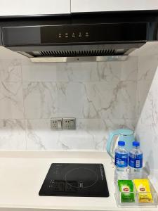 Una cocina o kitchenette en Golden Central Hotel Serviced Residence-Xin Hao E Du金中环服务公寓新浩e都店