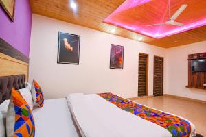 a bedroom with a large bed with a purple ceiling at FabHotel The Kasauli Heavens in Kasauli