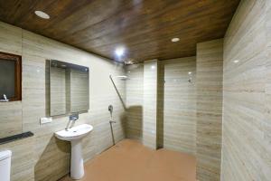 a bathroom with a sink and a mirror at FabHotel The Kasauli Heavens in Kasauli