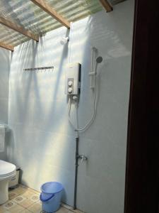 a shower in a bathroom with a toilet at HƯNG THÀNH HOME in Ben Tre