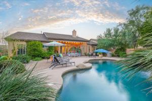 a swimming pool in front of a house at Phoenix Vacation Rentals in Phoenix