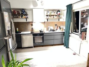 a kitchen with a refrigerator and a sink at Room in Stabekk Appartment in Stabekk