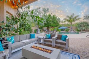 a patio with a couch and a fire pit at Phoenix Vacation Rentals in Phoenix