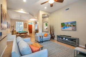 a living room with a couch and a tv at Phoenix Vacation Rentals in Phoenix