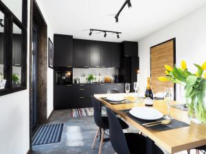 een keuken en eetkamer met een houten tafel en stoelen bij Mokre 22 in Bielsk Podlaski