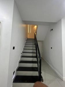 a stairway with black and white stairs in a building at Tropical oasis in Trivandrum