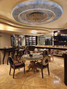 a dining room with a table and chairs and a ceiling at Q Hotel in Beirut