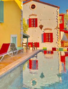 a house with a swimming pool in front of a house at Alaçatı Wellness Garden in Alacati
