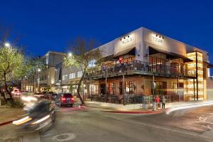 a building on the corner of a street at night at Scottsdale Vacation Rentals in Scottsdale