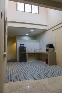 an empty room with a kitchen and a refrigerator at D Zorro HomeTel in Ipoh