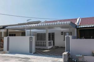 a house with a solarium in front of it at D Zorro HomeTel in Ipoh