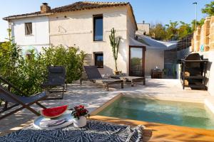 a villa with a swimming pool in front of a house at I COCCI DEL CASTELLO CASAVACANZE in Civitanova Alta