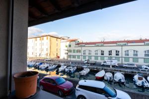 a view of a parking lot with cars and boats at AFFITTACAMERE I BIMBI in Livorno