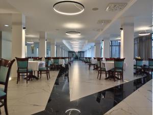 a dining room with a long table and chairs at Inex Olgica Hotel & SPA in Ohrid