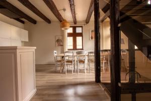 a kitchen and dining room with a table and chairs at Sous les toits de Sainte-Cécile in Albi