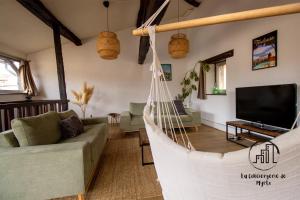 a living room with a hammock in a room at Sous les toits de Sainte-Cécile in Albi