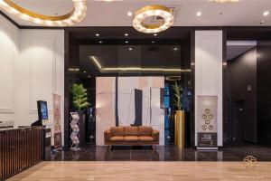 a lobby with a brown leather chair in a building at Chambers Kuala Lumpur by Five Senses in Kuala Lumpur