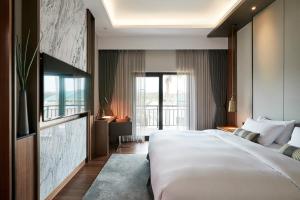 Postel nebo postele na pokoji v ubytování The Suites Hotel Jeju