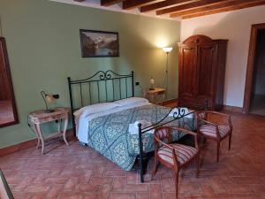 a bedroom with a bed and a table and chairs at Agriturismo Corte Spino in Nogarole Rocca +139 photos