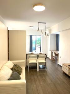a living room with a couch and a table at Arc de Triomphe apartment in Vientiane