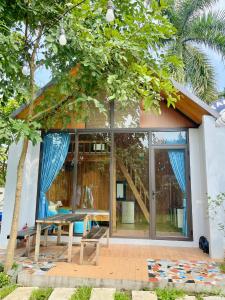 a house with glass doors and a table at T House - Venuestay in Ba Vì +32 photos