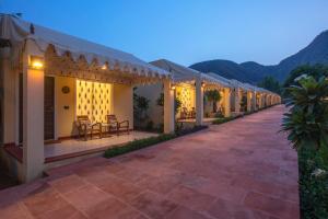 a row of houses with a patio at night at Ratan Villas Sariska in Alwar