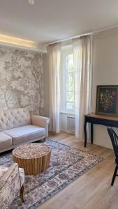 a living room with a couch and a table at The Brick House - Appartement Monet in La Roche-Guyon
