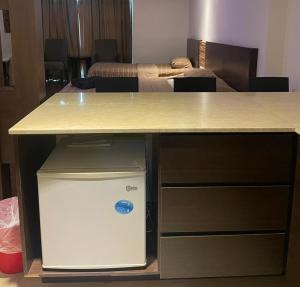 a table with a desk with a computer under it at Staycity Apartments - Kota Bharu City Point in Kota Bharu
