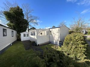 a couple of white modular homes in a yard at Beach Resort Kamperland - 642 in Kamperland