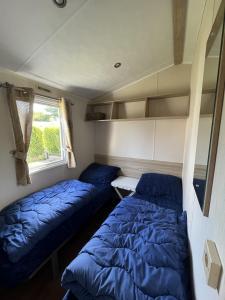 a bedroom with two beds and a window at Beach Resort Kamperland - 642 in Kamperland