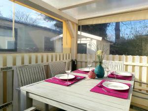 a table with red napkins and wine glasses on a porch at Beach Resort Kamperland - 642 in Kamperland