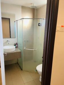 a bathroom with a shower and a toilet and a sink at Staycity Apartments - Kota Bharu City Point in Kota Bharu