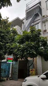a white car parked in front of a building at Love Hotel Hà Đông HN - by BAY LUXURY in Hà Ðông