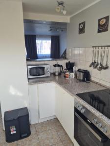 a kitchen with a counter top with a microwave at MM Apartment Wesseling in Wesseling
