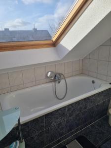 a bath tub in a bathroom with a window at MM Apartment Wesseling in Wesseling