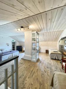 a large room with two beds and a wooden ceiling at Old Town B&B Ida-Maria in Porvoo