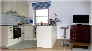 a kitchen with a counter and a television in it at Florian in Garmisch-Partenkirchen