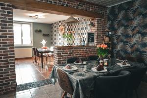 a dining room with a table and chairs at GITE , AU DORMEUR DU VAL in Vireux-Wallerand