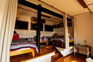 a bedroom with two beds in a room at Pequena Casa Holiday Home Malongane in Ponta Malongane
