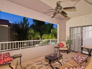 a living room with a ceiling fan and a balcony at Central Location, Heated Pool, Bbq, Hot Tub, More in Scottsdale