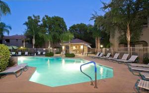 a large swimming pool with lounge chairs around it at Central Location, Heated Pool, Bbq, Hot Tub, More in Scottsdale