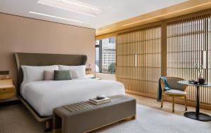 a bedroom with a bed and a table and a chair at Regent Hong Kong in Hong Kong