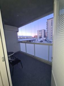 a room with a balcony with a table and a chair at MR Apartments 6 in Vaasa