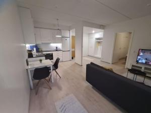 a large living room with a couch and a kitchen at MR Apartments 6 in Vaasa +1 photo