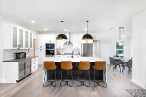 a kitchen with a large island with orange bar stools at Scottsdale Vacation Rentals in Phoenix