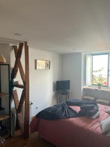a bedroom with a bed and a window at Alfama authentic Lisbon in Lisbon